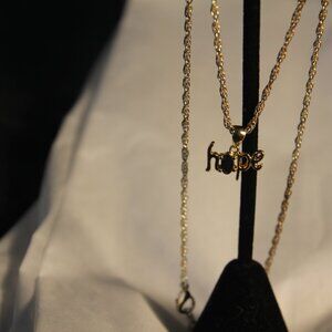 Hope gold tone necklace with black crystal. Like new condition.